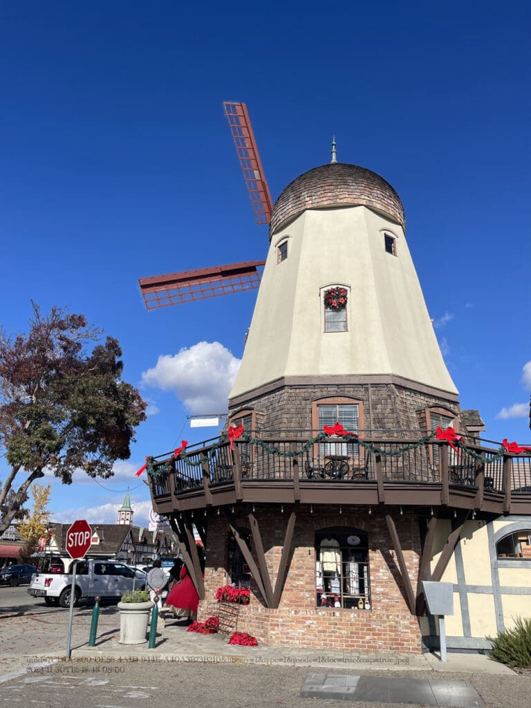 A windmill is shown in front of the sky.