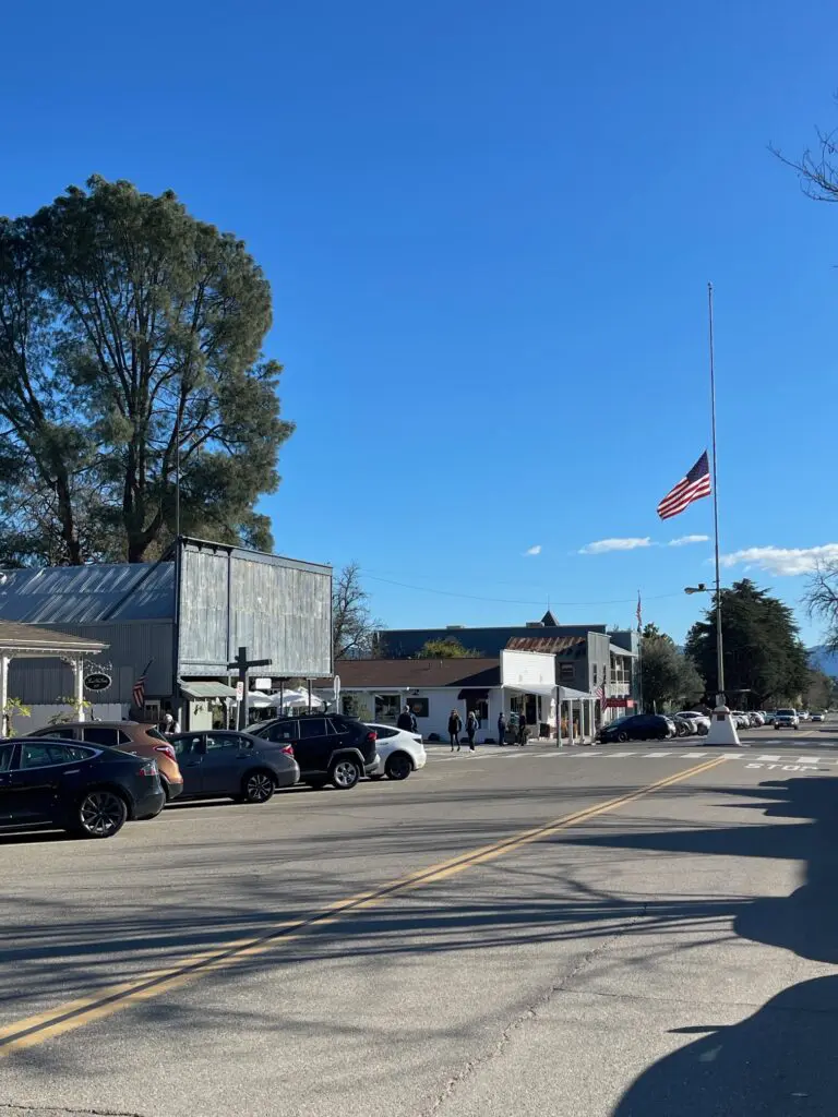 A street with cars parked on the side of it.